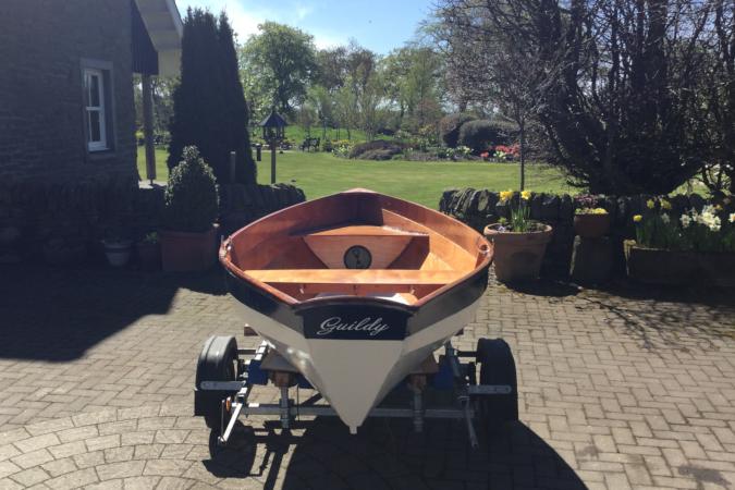 The Dinky Dory is a clinker-style wooden rowing boat