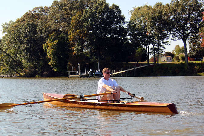 The Noank Pulling Boat is an efficient wooden sculling boat suitable for open water expeditions, using a drop-in sliding seat rowing unit